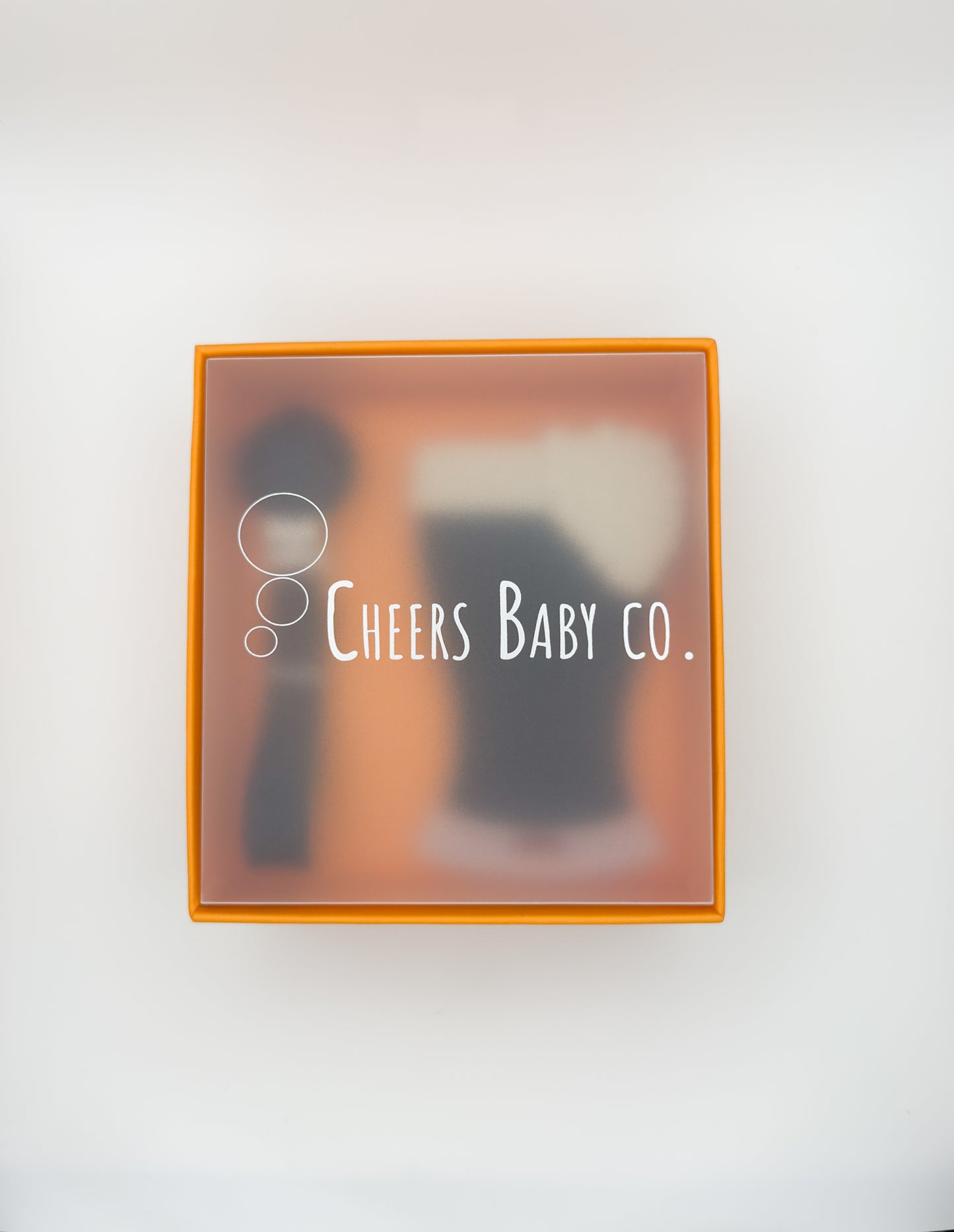 Cheers Baby Co. gift box with soft silicone teether design visible through the packaging on a white background