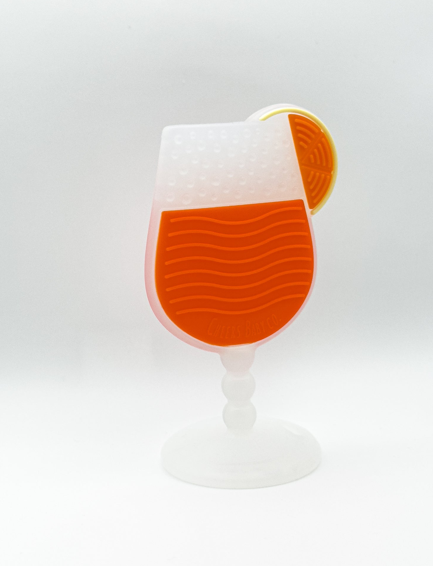 Soft silicone baby teether displayed upright on a white background with textured details